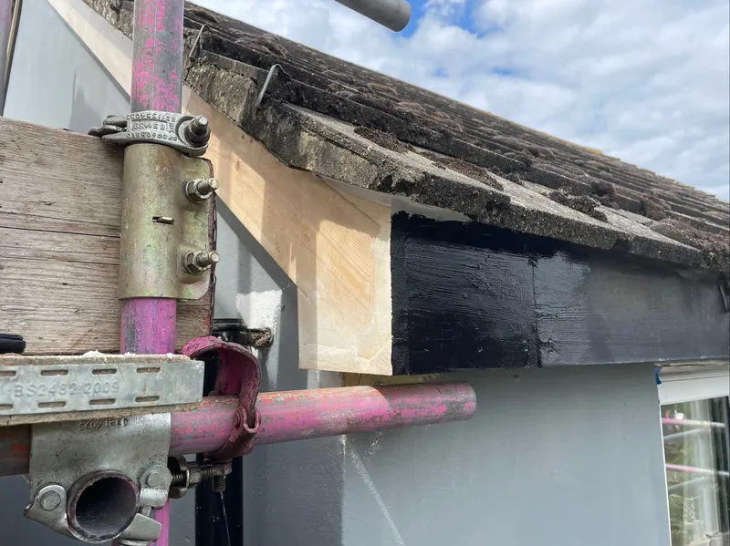 Wooden fascia board replacement on scaffolding