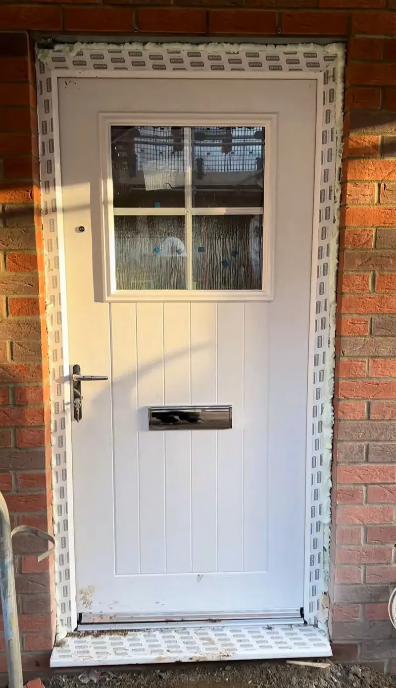 White front door fitting on new build